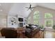 Bright living room featuring vaulted ceiling, fireplace, built-in shelving, hardwood floors and large windows at 330 Noah Pl, Mcdonough, GA 30252