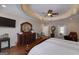 Comfortable main bedroom with trey ceiling, hardwood floors, flat screen television and furniture at 330 Noah Pl, Mcdonough, GA 30252