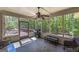 Cozy screened-in porch with natural light, a ceiling fan, and outdoor furniture at 330 Noah Pl, Mcdonough, GA 30252