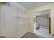 Walk-in closet with shelving leading to the bathroom with granite counter and glass shower at 330 Noah Pl, Mcdonough, GA 30252