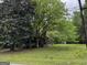 Rustic cabin-style home featuring mature trees and a charming stone chimney at 3935 Jailette Rd, South Fulton, GA 30349