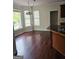 Breakfast nook with hardwood floors, three windows, and dark-colored trim at 5114 Verbena Nw Dr, Acworth, GA 30102