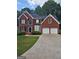 Charming brick two-story home with a well-maintained lawn and a two-car garage at 5114 Verbena Nw Dr, Acworth, GA 30102