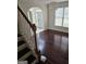 Bright foyer featuring hardwood floors, large window, and staircase at 5114 Verbena Nw Dr, Acworth, GA 30102