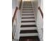 Staircase with hardwood steps and white wooden railings at 5114 Verbena Nw Dr, Acworth, GA 30102