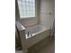 A relaxing garden tub is featured in this bright bathroom at 5114 Verbena Nw Dr, Acworth, GA 30102