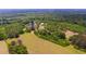 Expansive aerial view of a property featuring dual ponds, verdant forest, and open fields at 301 Spruill Bridge Rd, Temple, GA 30179