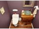 Compact bathroom showcasing a vessel sink on wooden vanity and framed mirror at 301 Spruill Bridge Rd, Temple, GA 30179