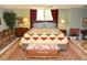 Large bedroom featuring a patterned quilt, comfortable furniture, and a pleasant, well-lit atmosphere at 301 Spruill Bridge Rd, Temple, GA 30179