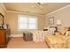 Bright bedroom with neutral walls, comfortable bed, a trunk, and a yellow chair for a restful and inviting space at 301 Spruill Bridge Rd, Temple, GA 30179