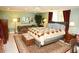 Comfortable bedroom with a large bed, a decorative quilt, and multiple seating options near the window at 301 Spruill Bridge Rd, Temple, GA 30179