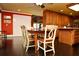 A dining area featuring a dark wood table, chairs, and dark wood floors next to an open kitchen at 301 Spruill Bridge Rd, Temple, GA 30179