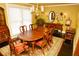 Dining room featuring a chandelier, hardwood floors, window, and a classic wooden dining table at 301 Spruill Bridge Rd, Temple, GA 30179