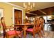 Dining room featuring a chandelier, wooden dining table, and an area rug, showcasing a warm ambiance at 301 Spruill Bridge Rd, Temple, GA 30179