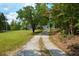 Long driveway leading to a property surrounded by trees, creating a sense of privacy and seclusion at 301 Spruill Bridge Rd, Temple, GA 30179