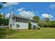 Exterior view of a home featuring a spacious screened porch and well-maintained lawn at 301 Spruill Bridge Rd, Temple, GA 30179