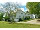 Spacious home exterior with lush landscaping, a long driveway, and attached garages at 301 Spruill Bridge Rd, Temple, GA 30179