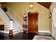 Foyer featuring hardwood floors, staircase, decorative accents, and stylish lighting fixture at 301 Spruill Bridge Rd, Temple, GA 30179