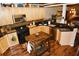 Kitchen featuring wooden cabinets, dark countertops, stainless steel appliances and a butcher block island at 301 Spruill Bridge Rd, Temple, GA 30179