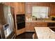 Modern kitchen featuring stainless steel appliances, granite countertops, and custom wood cabinets at 301 Spruill Bridge Rd, Temple, GA 30179