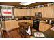 Kitchen featuring wooden cabinets, a mosaic backsplash, and stainless steel appliances and dark countertops at 301 Spruill Bridge Rd, Temple, GA 30179