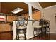 Kitchen featuring wooden cabinets, dark countertops, mosaic backsplash, and barstool seating at 301 Spruill Bridge Rd, Temple, GA 30179