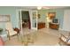 Well-lit living room with light blue walls, tile floors, comfortable seating, and an open doorway to another room at 301 Spruill Bridge Rd, Temple, GA 30179