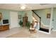 Living room with tiled floors, a staircase and comfortable seating, providing a relaxing and functional living space at 301 Spruill Bridge Rd, Temple, GA 30179