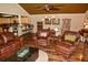 Open-concept living space with hardwood floors and comfortable seating adjacent to kitchen with barstool seating at 301 Spruill Bridge Rd, Temple, GA 30179