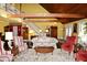 A living room with high ceilings, exposed beams, dark wood floors, and a staircase at 301 Spruill Bridge Rd, Temple, GA 30179