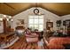 Spacious living room featuring hardwood floors, a large window, and comfortable leather seating at 301 Spruill Bridge Rd, Temple, GA 30179