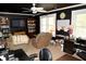 Cozy living room features dark accent walls, bright windows, comfortable seating and built-in shelving for storage and decor at 301 Spruill Bridge Rd, Temple, GA 30179