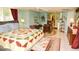 Open living space with bedroom view. Includes a sewing table, a dining area, and other functional furniture at 301 Spruill Bridge Rd, Temple, GA 30179