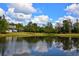 Beautiful view of a pond reflecting the surrounding trees and sky, creating a peaceful and inviting outdoor space at 301 Spruill Bridge Rd, Temple, GA 30179