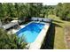 Aerial view of a private in-ground swimming pool surrounded by a white fence and landscaped yard at 301 Spruill Bridge Rd, Temple, GA 30179
