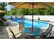 Enjoy outdoor dining with a view of the sparkling swimming pool and lush backyard at 301 Spruill Bridge Rd, Temple, GA 30179