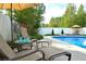 Poolside seating for lounging by the refreshing swimming pool and landscaped backyard at 301 Spruill Bridge Rd, Temple, GA 30179