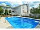Large backyard pool with a diving board, patio area, and ample seating, perfect for outdoor entertaining at 301 Spruill Bridge Rd, Temple, GA 30179