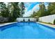 Large backyard swimming pool perfect for summer fun and relaxation, surrounded by lush greenery at 301 Spruill Bridge Rd, Temple, GA 30179