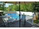 Relaxing poolside deck area with a refreshing swimming pool and outdoor seating under an umbrella at 301 Spruill Bridge Rd, Temple, GA 30179