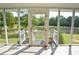 Charming screened porch entry with serene views of a lush, tree-lined pond at 301 Spruill Bridge Rd, Temple, GA 30179