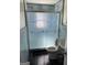 Bathroom with a standing toilet and a shower enclosed by an artistic glass door at 1025 Lynwood Pl, Forest Park, GA 30297