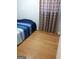 This bedroom has hardwood floors and patterned curtains at 1025 Lynwood Pl, Forest Park, GA 30297