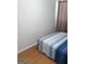 Cozy bedroom features a blue striped bedspread and wood flooring at 1025 Lynwood Pl, Forest Park, GA 30297