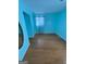 A bright bedroom featuring hardwood floors, blue walls and natural light at 1025 Lynwood Pl, Forest Park, GA 30297