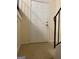 Interior view of a white door, beige wall and stairs with black railing at 1025 Lynwood Pl, Forest Park, GA 30297