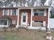 Traditional brick home featuring a covered front porch and shuttered windows at 1025 Lynwood Pl, Forest Park, GA 30297