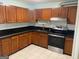 Kitchen featuring wooden cabinets, black countertops, and stainless steel appliances at 1025 Lynwood Pl, Forest Park, GA 30297