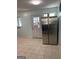 Well lit kitchen with tile floor, stainless steel refrigerator and a back door at 1025 Lynwood Pl, Forest Park, GA 30297