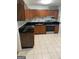 Kitchen featuring wooden cabinets, black countertops, and stainless steel appliances at 1025 Lynwood Pl, Forest Park, GA 30297